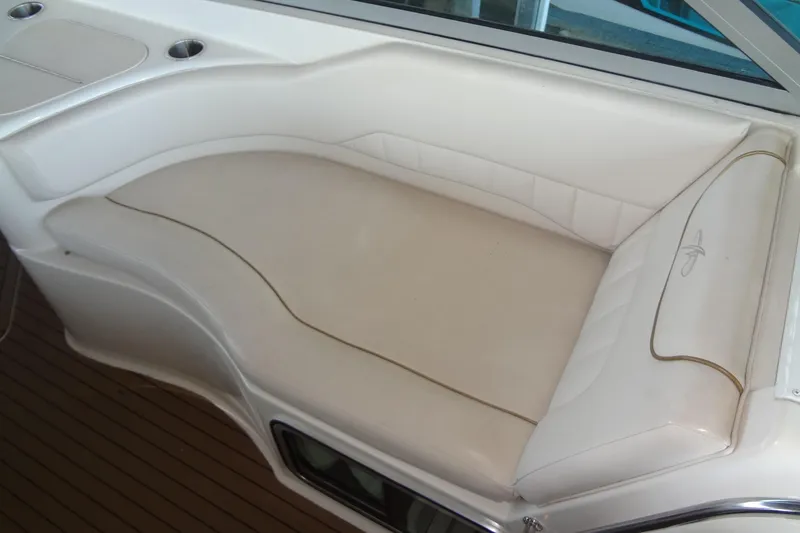 Slide: The Image of Luxurious seating on a 2000 Monterey 302 Cruiser boat, featuring white upholstery. - 15