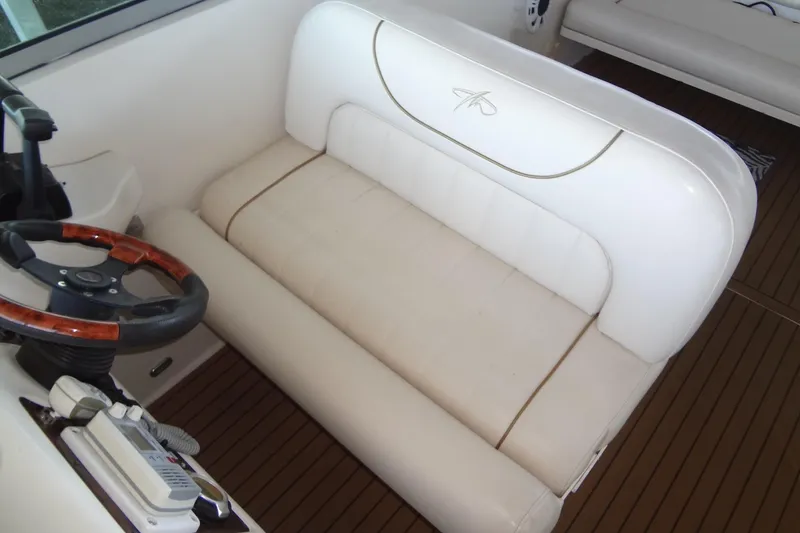Slide: The Image of 2000 Monterey 302 Cruiser interior with white seating and wooden steering wheel. - 17