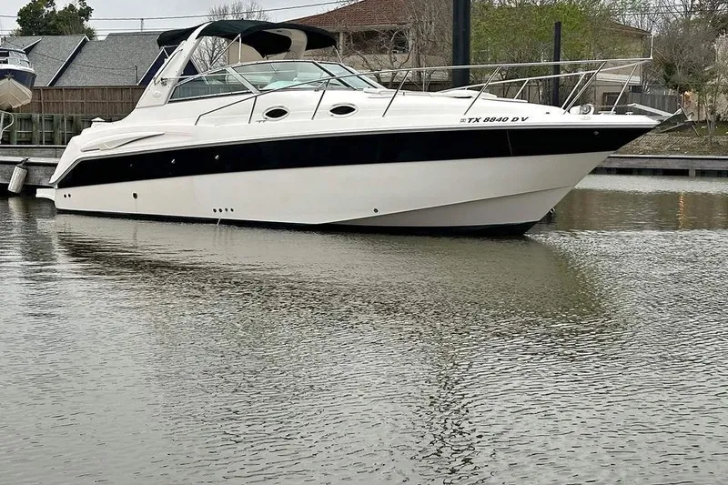 Slide: The Image of 2000 Monterey 302 Cruiser boat docked on calm water. - 2
