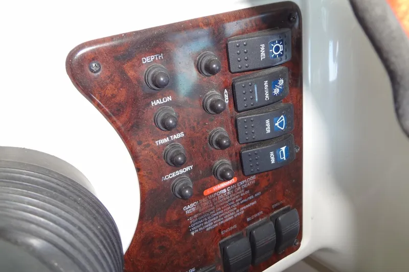 Slide: The Image of Control panel of a 2000 Monterey 302 Cruiser boat with various switches and labels. - 22