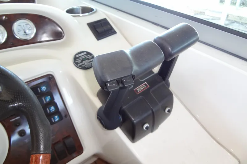 Slide: The Image of Control panel of 2000 Monterey 302 Cruiser boat with throttle and gauges. - 23