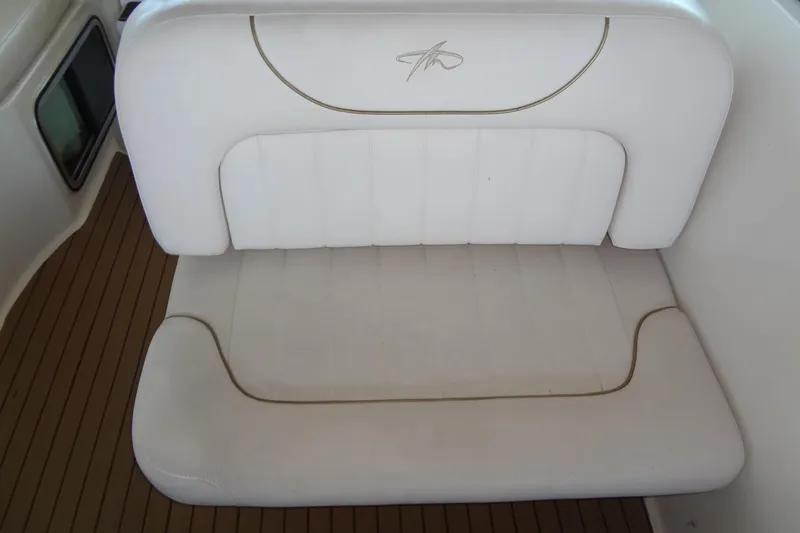 Slide: The Image of White cushioned seat on 2000 Monterey 302 Cruiser boat, with teak flooring. - 25