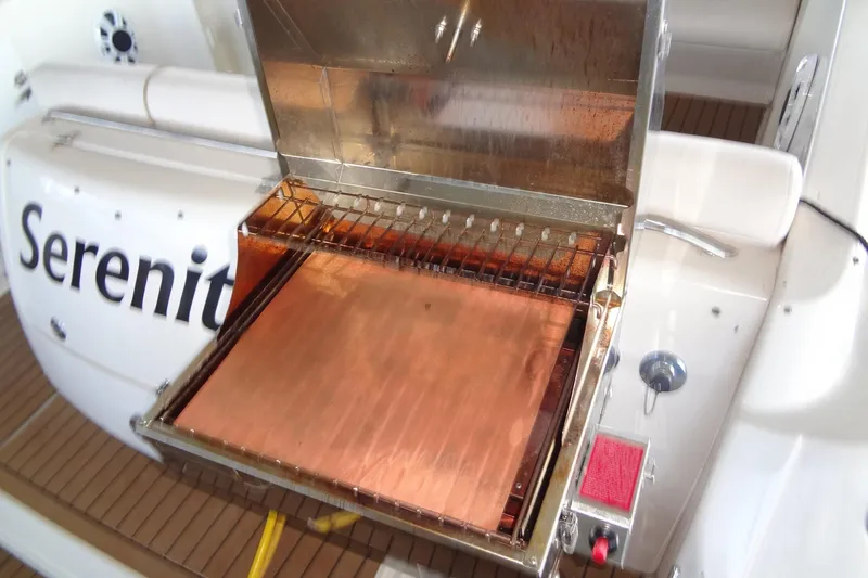 Slide: The Image of Outdoor grill on 2000 Monterey 302 Cruiser boat deck. - 31