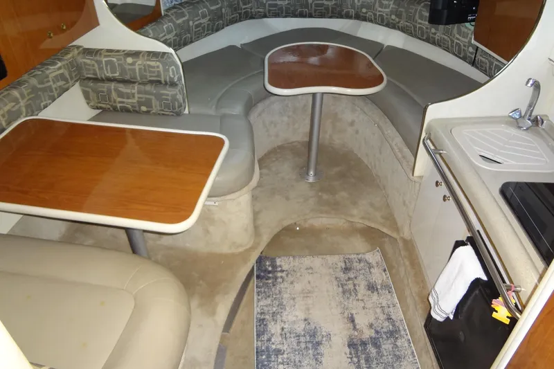 Slide: The Image of Interior of 2000 Monterey 302 Cruiser with seating, tables, and kitchenette. - 33
