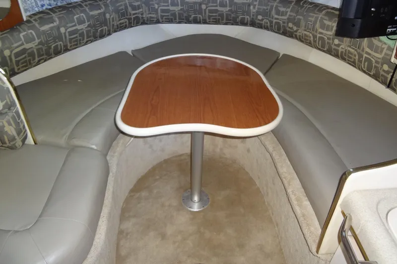Slide: The Image of Interior of a 2000 Monterey 302 Cruiser with a cozy seating area and wooden table. - 34