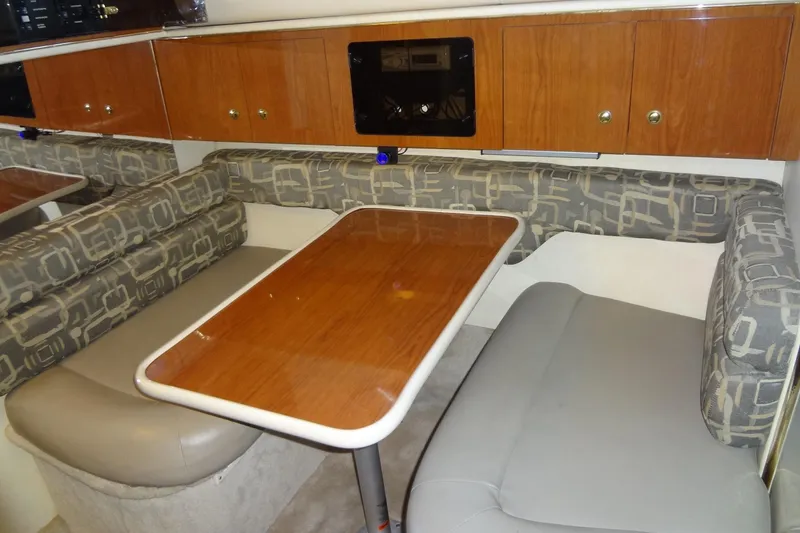 Slide: The Image of Interior of 2000 Monterey 302 Cruiser with dining area and wooden cabinetry. - 35