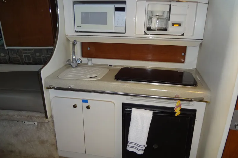 Slide: The Image of Compact kitchen area in a 2000 Monterey 302 Cruiser with microwave, sink, and coffee maker. - 36