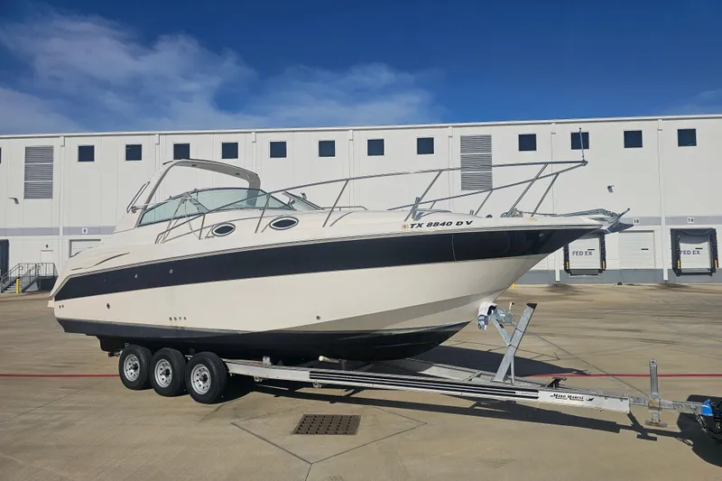 Slide: The Image of 2000 Monterey 302 Cruiser boat on trailer in industrial setting. - 4