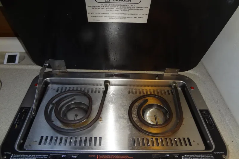 Slide: The Image of Electric stove with dual burners on a 2000 Monterey 302 Cruiser boat. - 40
