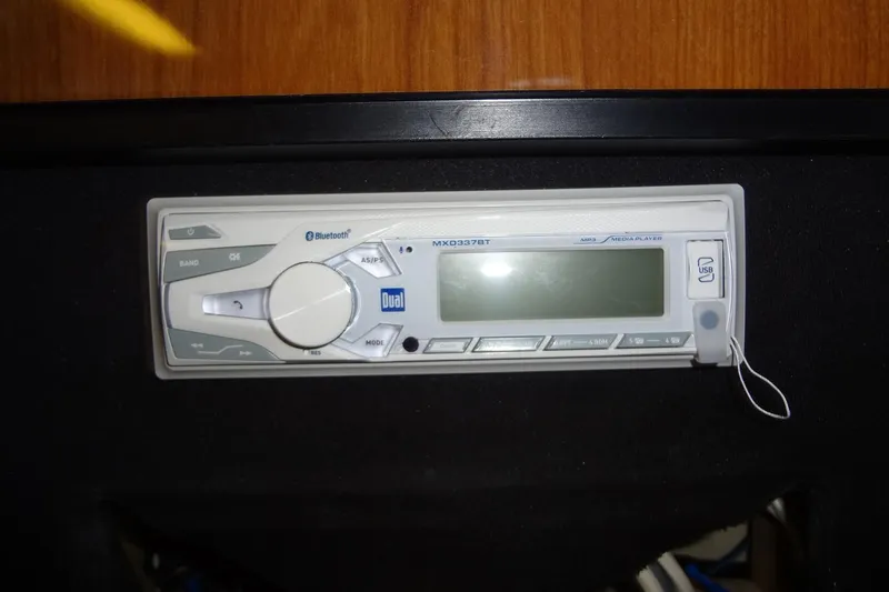 Slide: The Image of Bluetooth-enabled media player in a 2000 Monterey 302 Cruiser boat dashboard. - 43