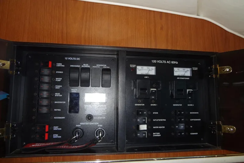 Slide: The Image of Electrical control panel on a 2000 Monterey 302 Cruiser boat, featuring 12V DC and 120V AC systems. - 44