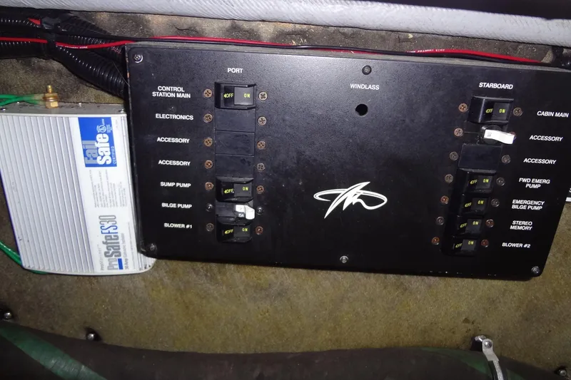 Slide: The Image of Electrical panel of a 2000 Monterey 302 Cruiser boat with labeled switches. - 51