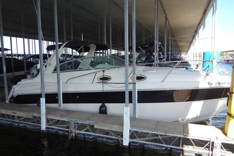 Slide: The Image of 2000 Monterey 302 Cruiser docked in a covered marina. - 6