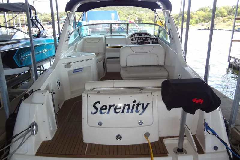 Slide: The Image of 2000 Monterey 302 Cruiser named Serenity docked at a marina, showcasing spacious seating. - 8