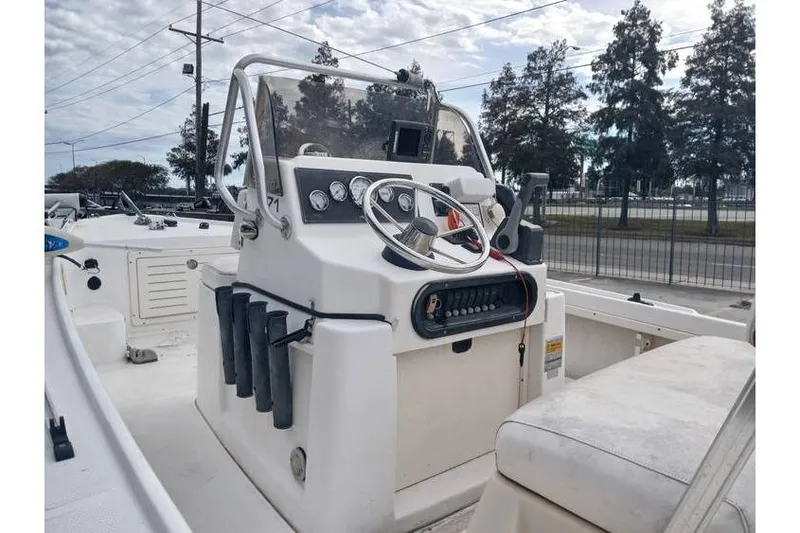 Slide: The Image of 2001 Mako 171 Center Console boat with steering wheel and control panel. - 3