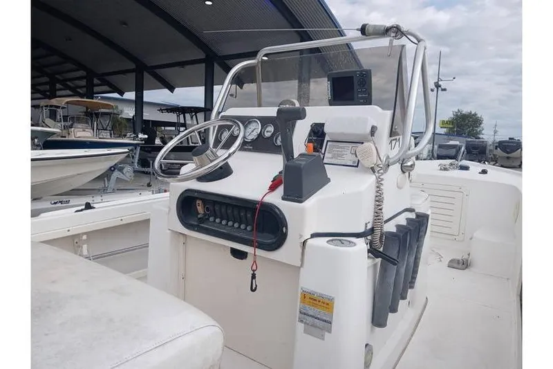 Slide: The Image of 2001 Mako 171 Center Console boat interior with steering wheel and control panel. - 4