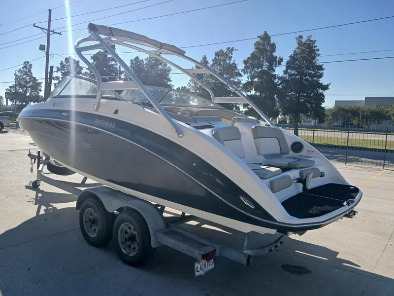 Slide: The Image of 2010 Yamaha Boats 242 Limited interior with gray seating and speakers. - 10