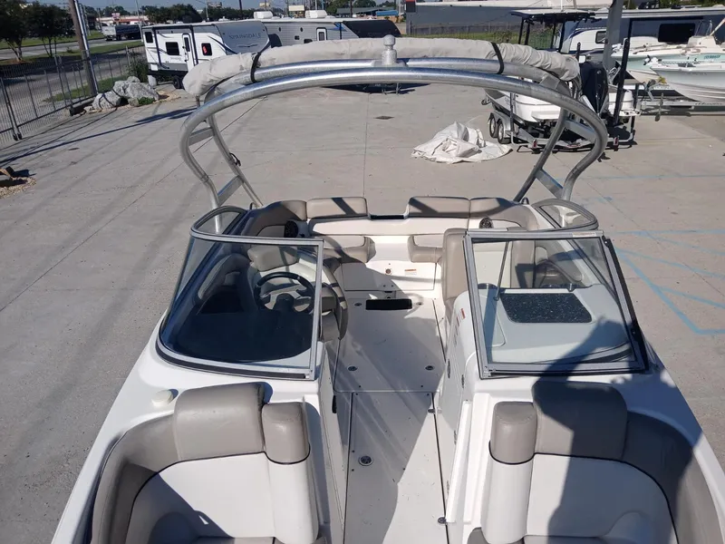 Slide: The Image of 2010 Yamaha Boats 242 Limited, open deck view, parked in a marina. - 5