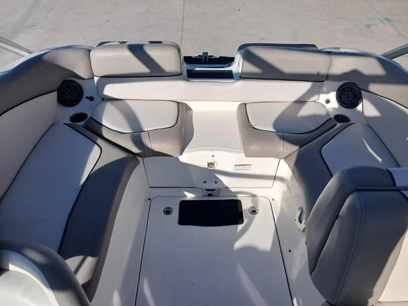 Slide: The Image of 2010 Yamaha Boats 242 Limited interior with cushioned seating and table. - 8