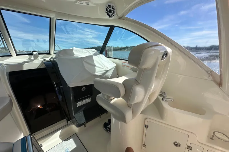 Slide: The Image of Interior of a 2010 Pursuit OS 315 Offshore boat with helm seat and windows. - 10