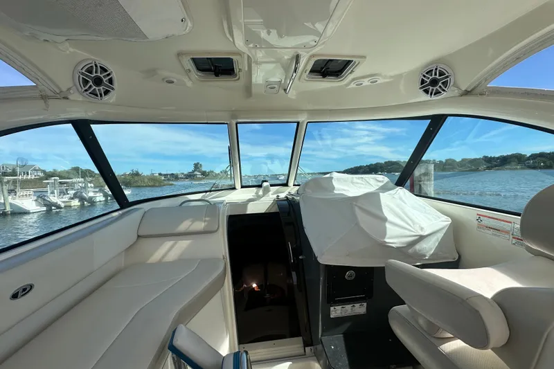 Slide: The Image of Interior view of 2010 Pursuit OS 315 Offshore boat with scenic water backdrop. - 11