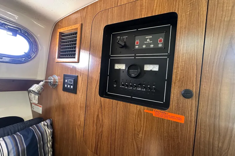 Slide: The Image of Control panel inside 2010 Pursuit OS 315 Offshore boat, featuring wood paneling and gauges. - 17