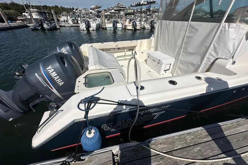 Slide: The Image of 2010 Pursuit OS 315 Offshore boat with Yamaha engines docked at marina. - 20