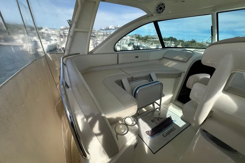 Slide: The Image of 2010 Pursuit OS 315 Offshore boat interior with white seating and large windows. - 8