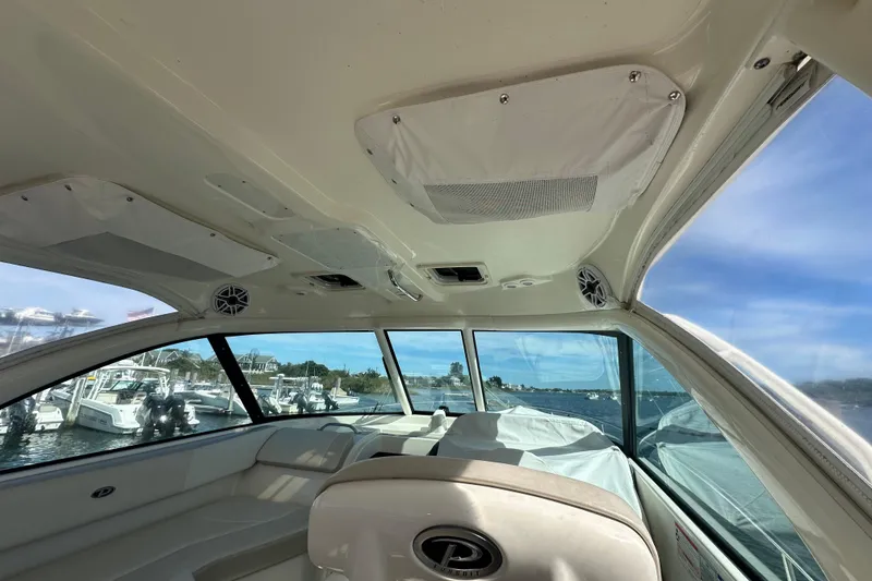 Slide: The Image of Interior view of 2010 Pursuit OS 315 Offshore boat with windows and seating. - 9