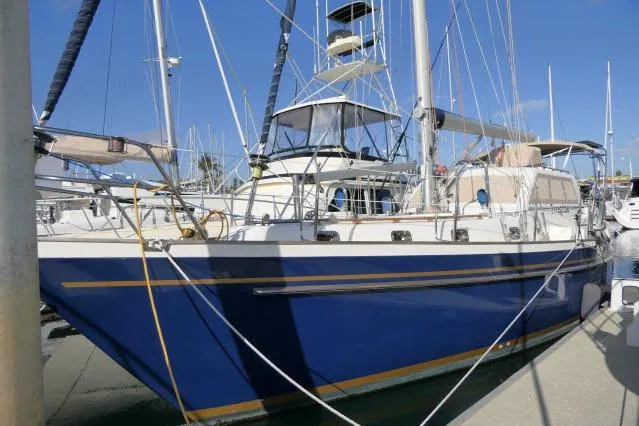Slide: The Image of 2002 Tayana 460 Vancouver Pilothouse sailboat docked in marina, blue hull, sunny day. - 104