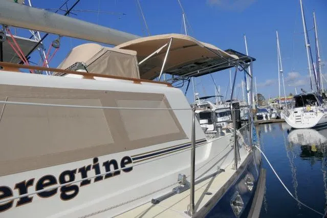 Slide: The Image of 2002 Tayana 460 Vancouver Pilothouse yacht docked at marina under clear blue sky. - 105