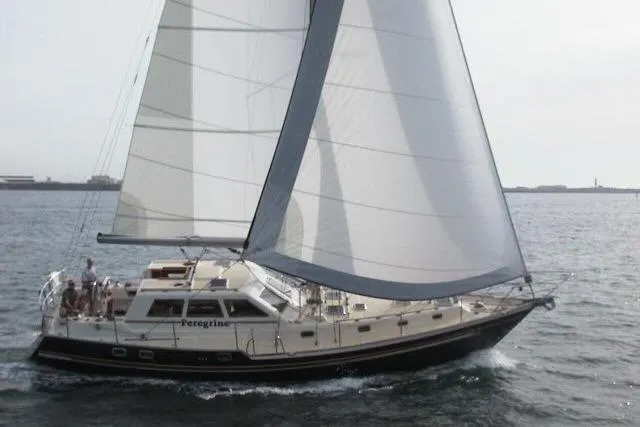 Slide: The Image of 2002 Tayana 460 Vancouver Pilothouse sailing on open water, full sails, side view. - 107