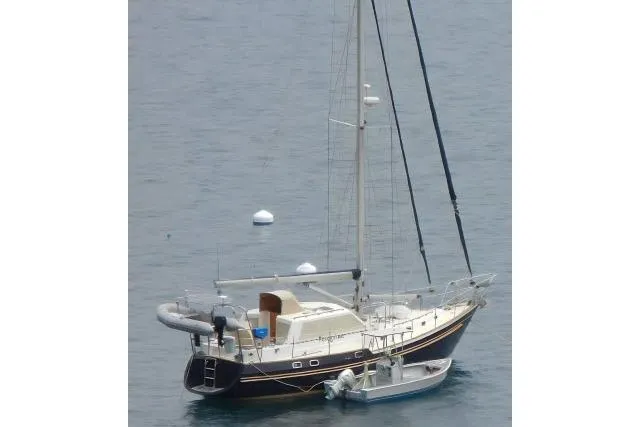 Slide: The Image of 2002 Tayana 460 Vancouver Pilothouse sailboat anchored in calm waters. - 110
