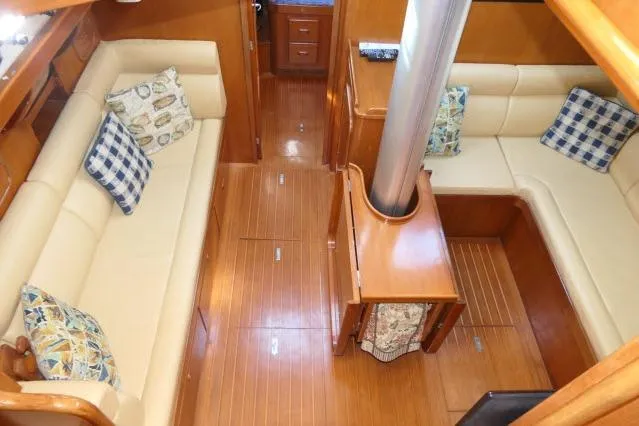Slide: The Image of Interior of 2002 Tayana 460 Vancouver Pilothouse with wooden flooring and cushioned seating. - 13
