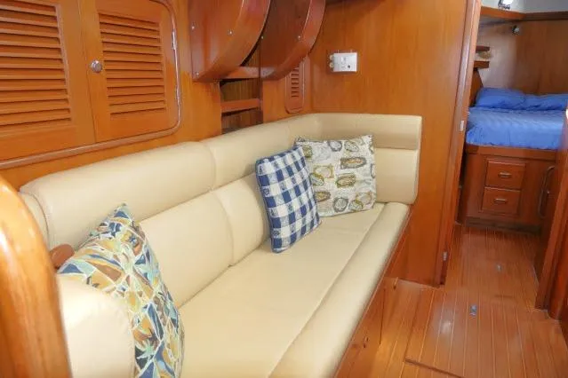 Slide: The Image of Luxurious interior of 2002 Tayana 460 Vancouver Pilothouse with beige sofa and decorative pillows. - 18