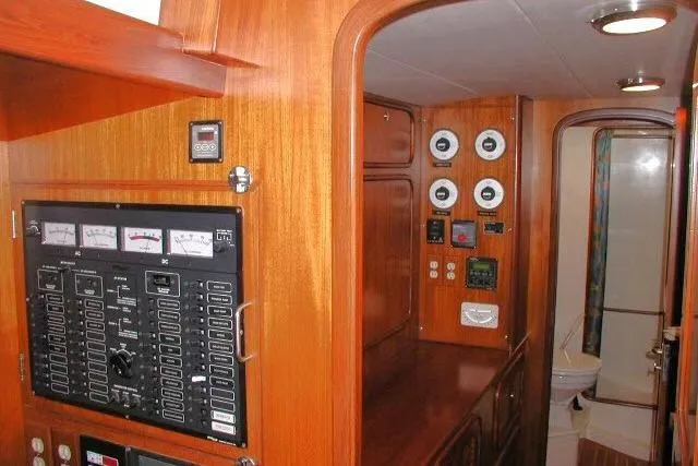 Slide: The Image of 2002 Tayana 460 Vancouver Pilothouse interior with control panels and wood finish. - 26
