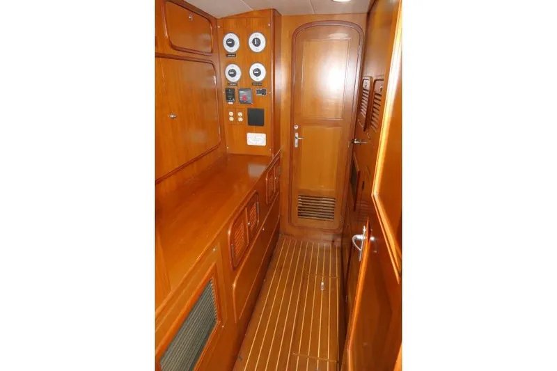 Slide: The Image of Interior of 2002 Tayana 460 Vancouver Pilothouse with wooden cabinetry and control panels. - 28