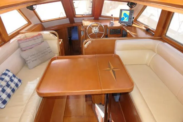 Slide: The Image of Luxurious 2002 Tayana 460 Vancouver Pilothouse interior with elegant wood and leather seating. - 4