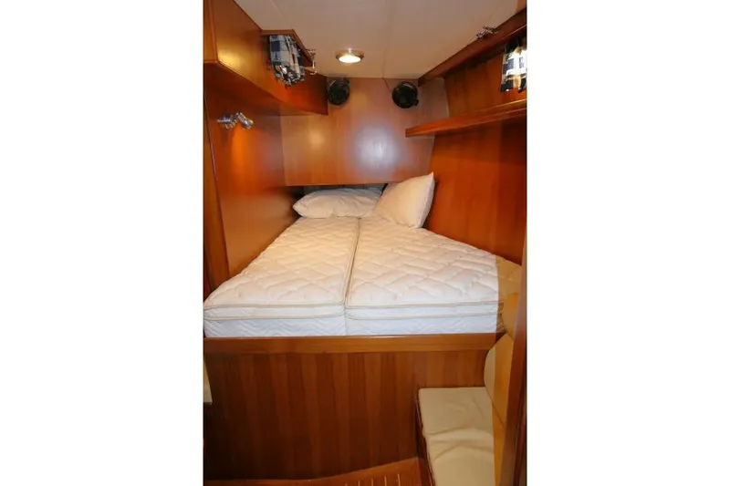 Slide: The Image of Cozy cabin interior of 2002 Tayana 460 Vancouver Pilothouse with wooden finish and comfortable bedding. - 40