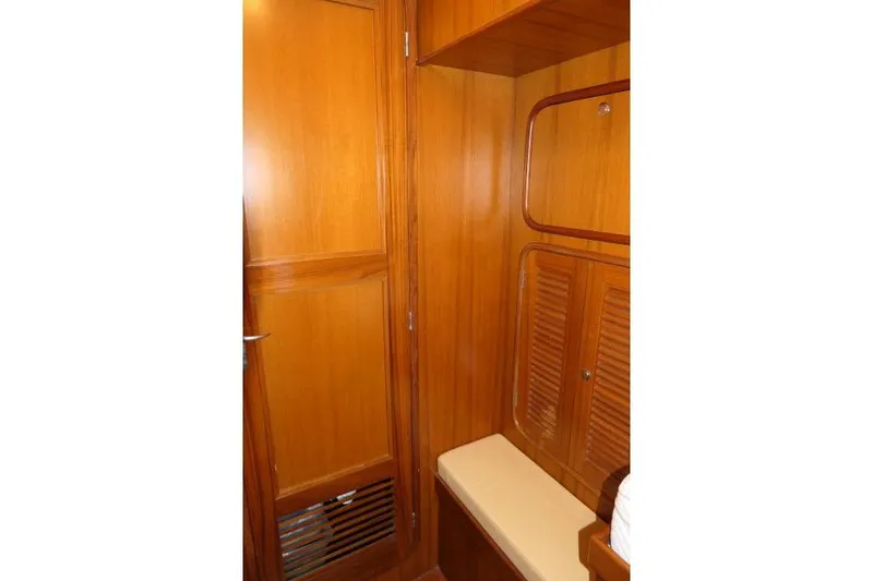 Slide: The Image of Wooden interior of 2002 Tayana 460 Vancouver Pilothouse, featuring storage and seating. - 42