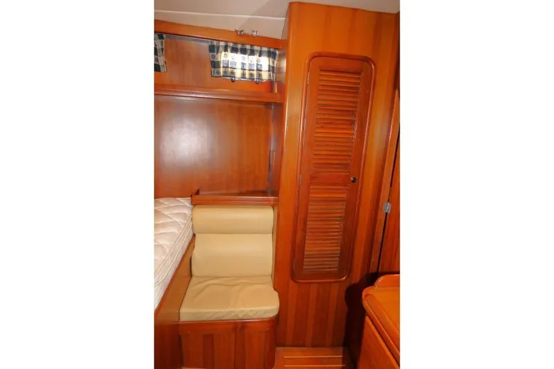 Slide: The Image of 2002 Tayana 460 Vancouver Pilothouse interior with wooden cabinetry and seating area. - 45