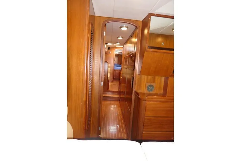 Slide: The Image of Interior of 2002 Tayana 460 Vancouver Pilothouse, featuring polished wood paneling and cabinetry. - 46