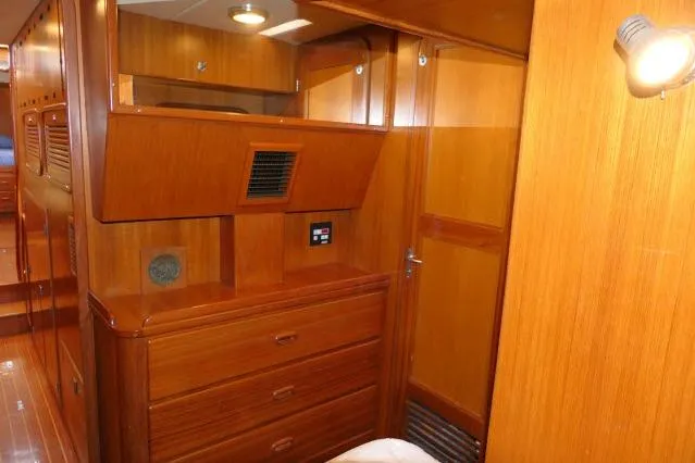 Slide: The Image of Interior of 2002 Tayana 460 Vancouver Pilothouse with wooden cabinetry and lighting. - 47