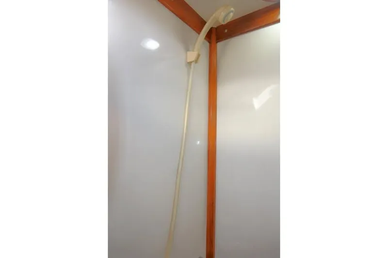 Slide: The Image of Shower area in 2002 Tayana 460 Vancouver Pilothouse with wooden trim and white walls. - 56