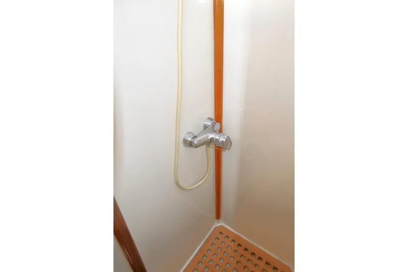 Slide: The Image of Shower area in 2002 Tayana 460 Vancouver Pilothouse with chrome fixtures and wooden accents. - 58