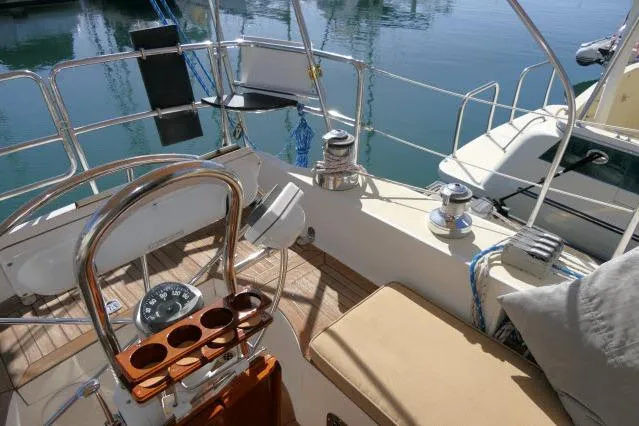 Slide: The Image of 2002 Tayana 460 Vancouver Pilothouse yacht cockpit with steering wheel and seating. - 62
