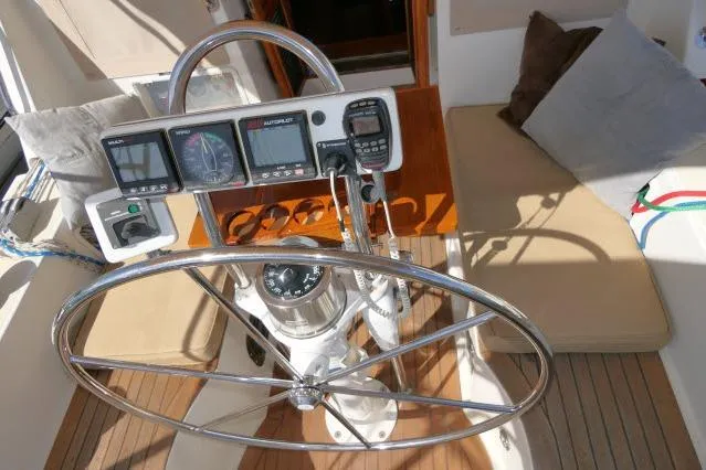 Slide: The Image of Pilothouse of 2002 Tayana 460 Vancouver, featuring steering wheel and navigation instruments. - 65