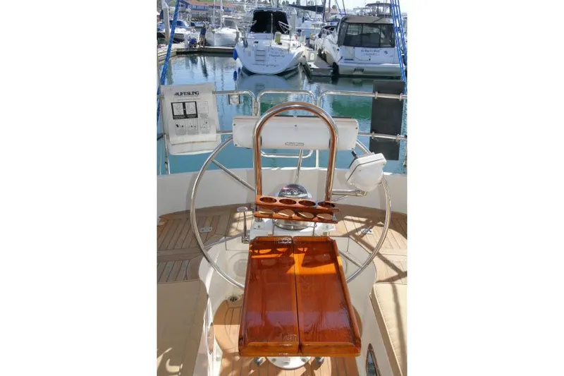 Slide: The Image of Pilothouse helm of 2002 Tayana 460 Vancouver, featuring a wooden seat and steering wheel. - 67