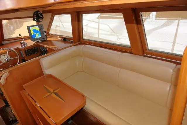 Slide: The Image of Pilothouse interior of 2002 Tayana 460 Vancouver, featuring a beige sofa and navigation equipment. - 7
