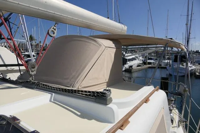 Slide: The Image of 2002 Tayana 460 Vancouver Pilothouse sailboat docked at marina, featuring beige canopy. - 73